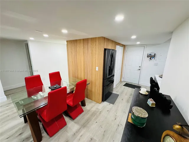 a living room with furniture and floor to ceiling window