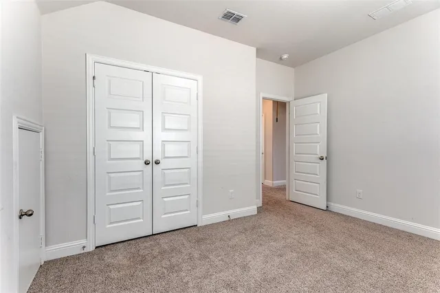 an empty room with closet area