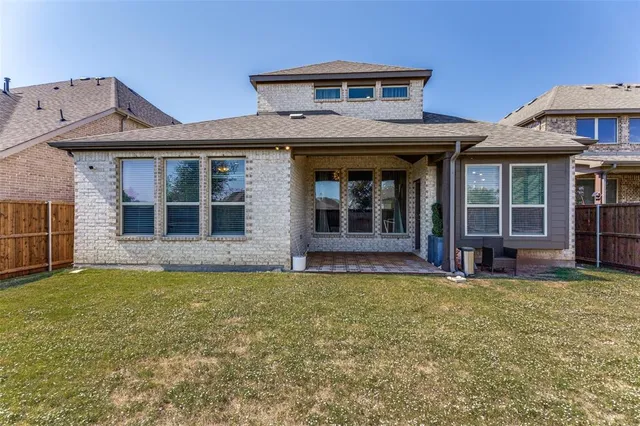 a view of a house with a yard and sitting area