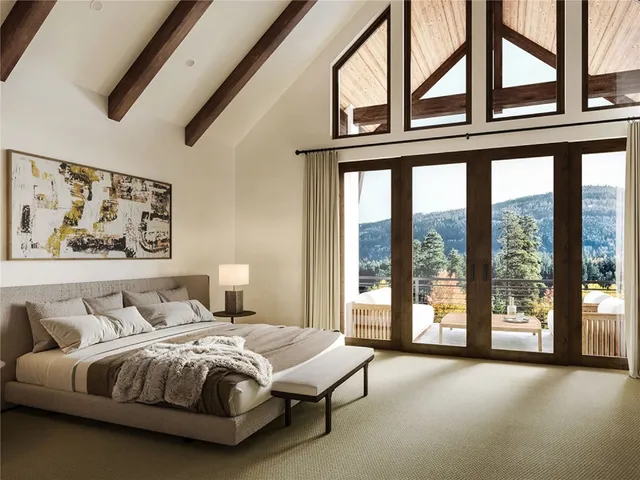 a spacious bedroom with a bed and a large window