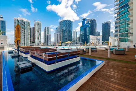 a swimming pool with outdoor seating and yard