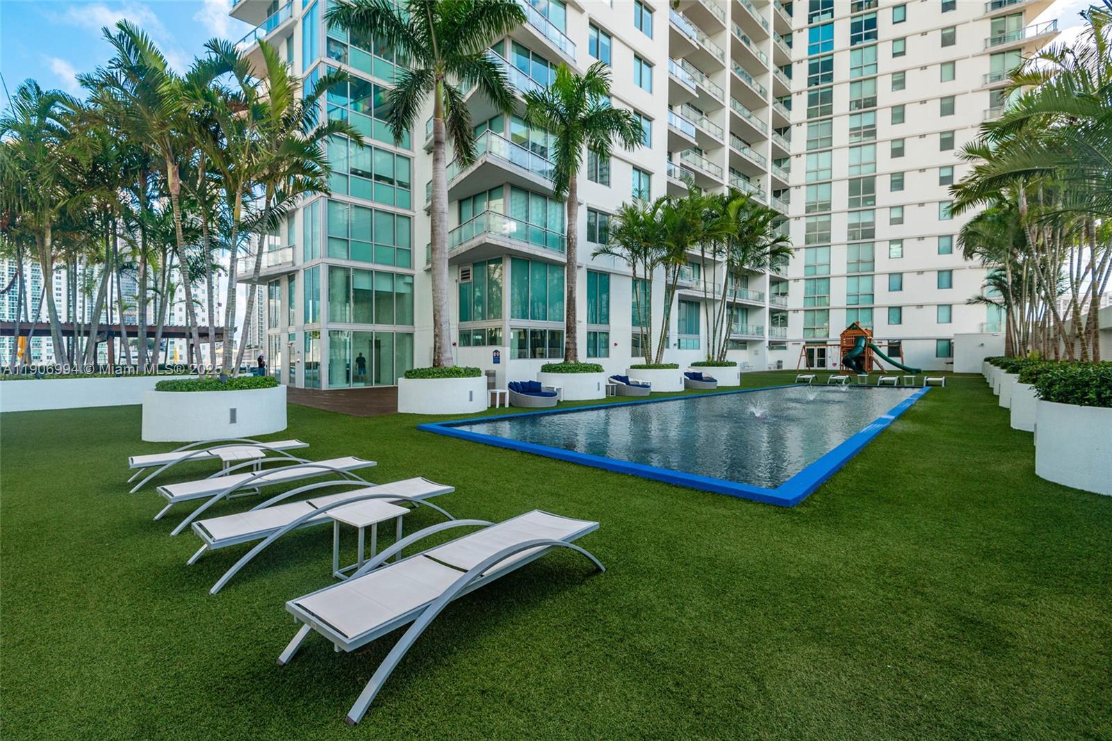 92 Southwest 3rd Street, Unit 3503 Miami, FL 33130 - Photo 34 of 35 a swimming pool with outdoor seating and yard