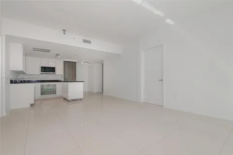 a view of kitchen with granite countertop cabinets and white appliances