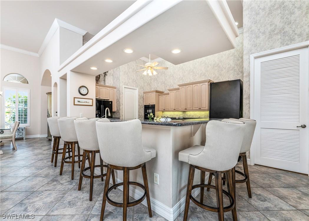 3290 Sugarloaf Key Road Punta Gorda, FL 33955 - Photo 11 of 50 a kitchen with stainless steel appliances kitchen island granite countertop a dining table chairs and a refrigerator