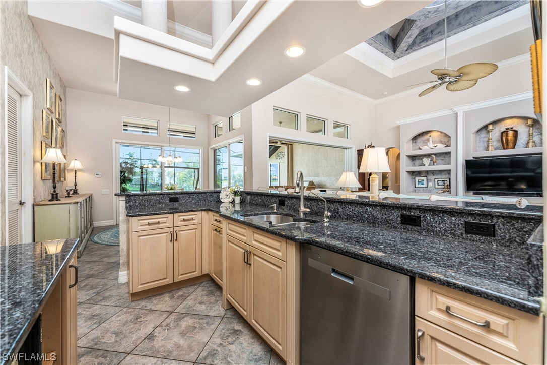 3290 Sugarloaf Key Road Punta Gorda, FL 33955 - Photo 14 of 50 a large kitchen with granite countertop a sink and dishwasher a oven with wooden cabinets