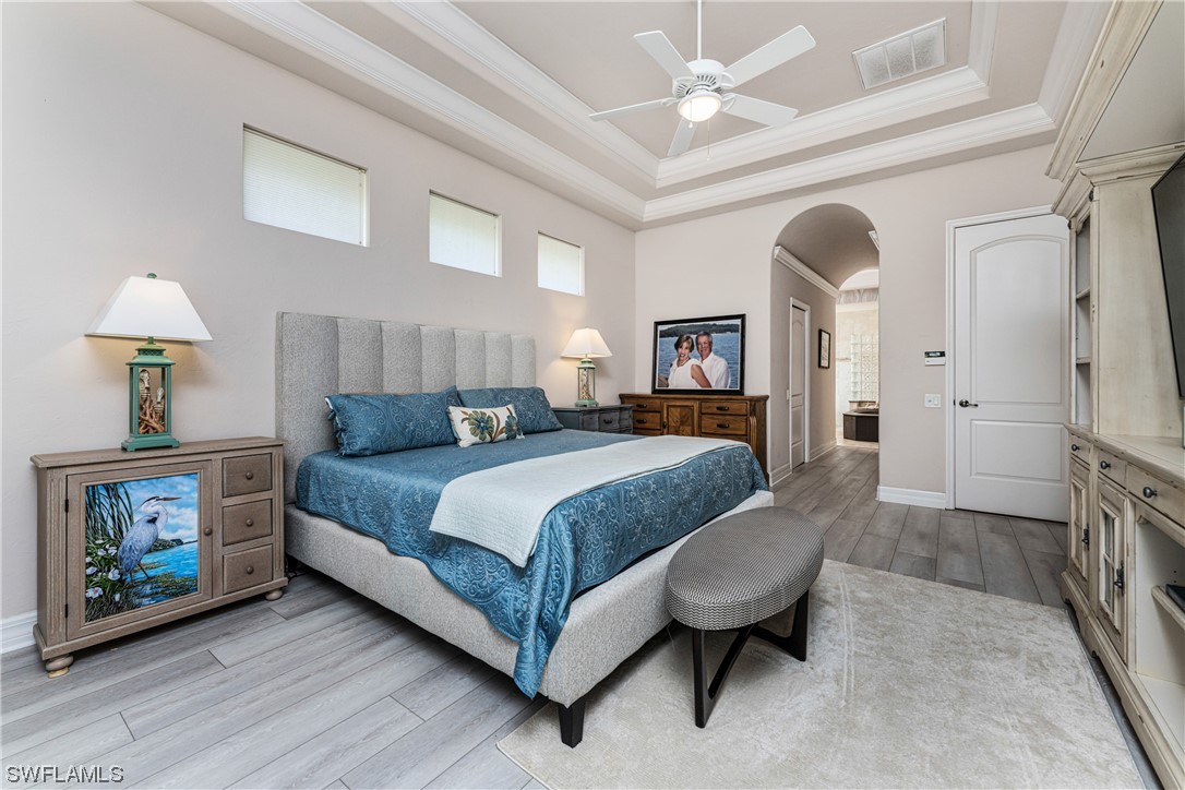 3290 Sugarloaf Key Road Punta Gorda, FL 33955 - Photo 22 of 50 a spacious bedroom with a bed a mirror and a lamp on dresser