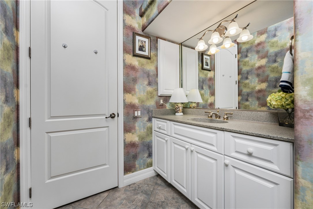 3290 Sugarloaf Key Road Punta Gorda, FL 33955 - Photo 31 of 50 a bathroom with a double vanity sink and mirror