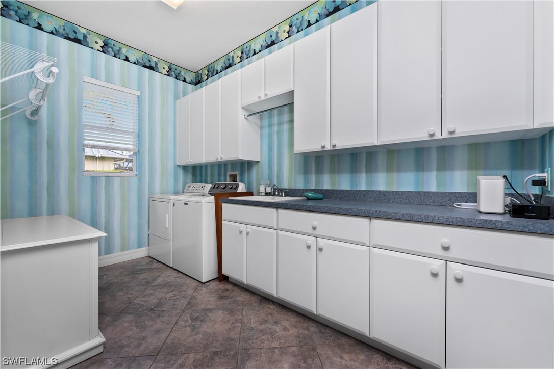 3290 Sugarloaf Key Road Punta Gorda, FL 33955 - Photo 36 of 50 a kitchen with cabinets appliances a sink and a window