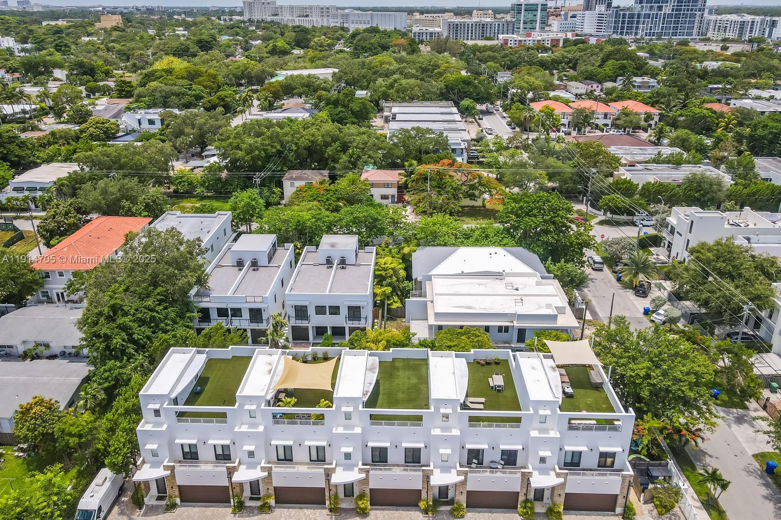 an aerial view of residential houses with outdoor space and street view