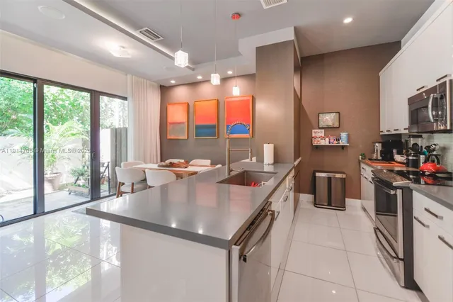 a kitchen with a stove a sink and a refrigerator