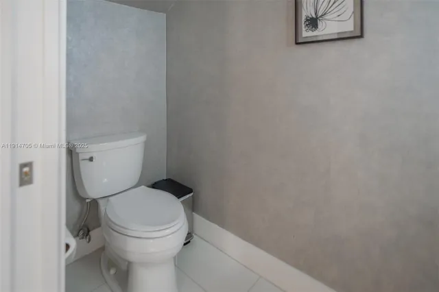a white toilet sitting next to a small bathroom