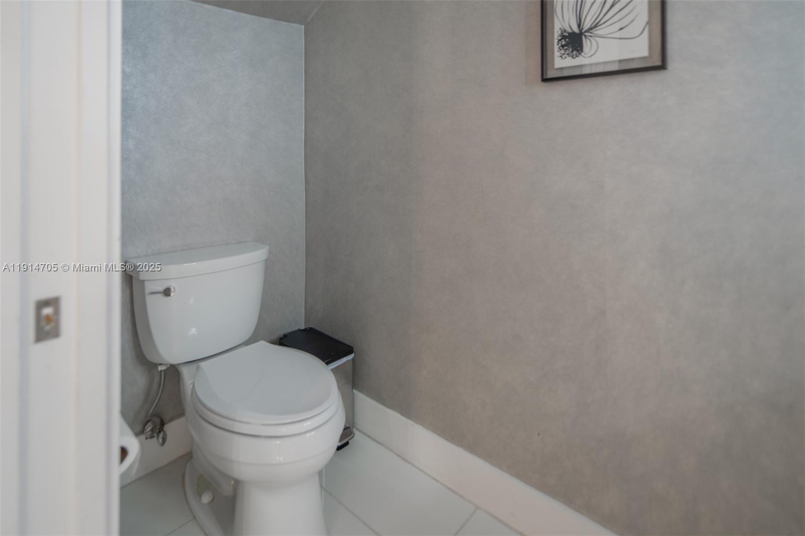 3318 Day Avenue, Unit 7 Miami, FL 33133 - Photo 17 of 39 a white toilet sitting next to a small bathroom