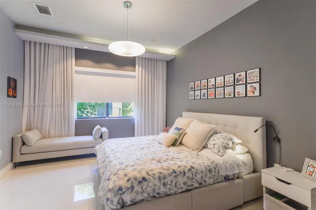 a bedroom with a bed and a large window