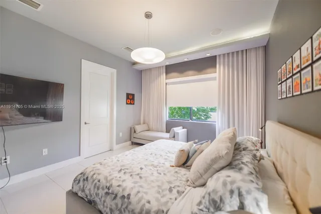 a bedroom with a large bed and a large window