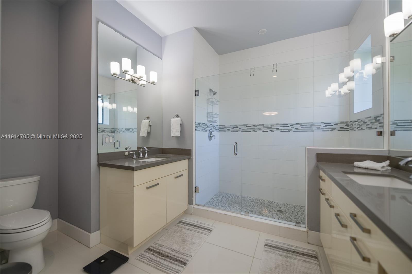 3318 Day Avenue, Unit 7 Miami, FL 33133 - Photo 22 of 39 a spacious bathroom with a granite countertop sink a toilet and shower