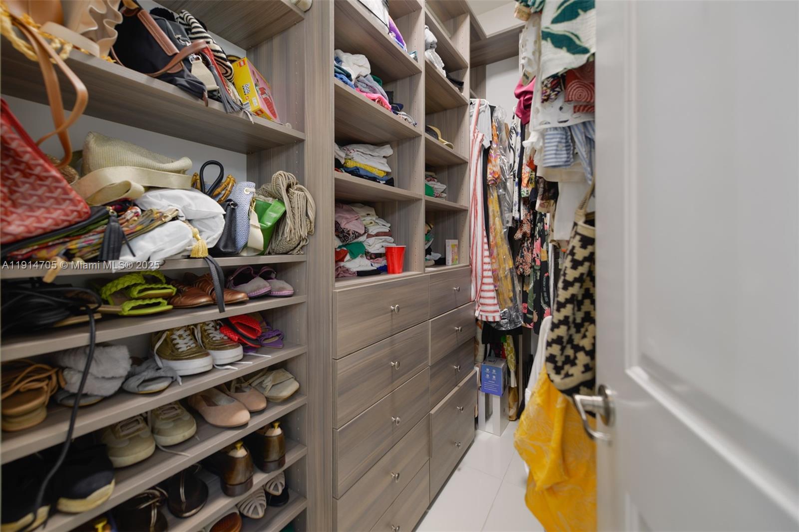 3318 Day Avenue, Unit 7 Miami, FL 33133 - Photo 25 of 39 a view of walk in closet with clothes and shoes