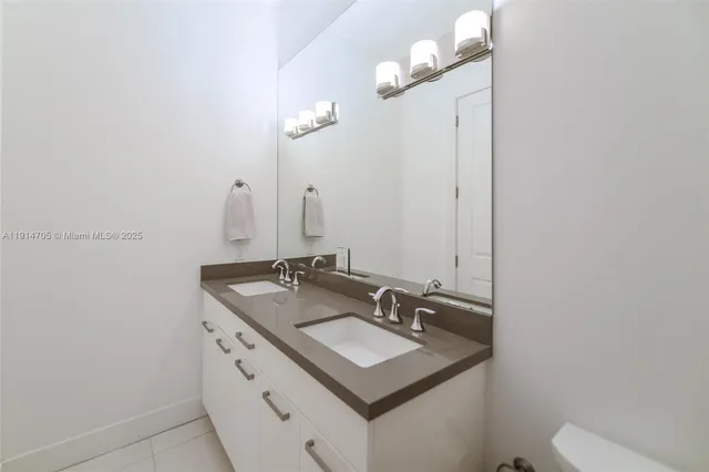 a bathroom with a sink vanity and a mirror