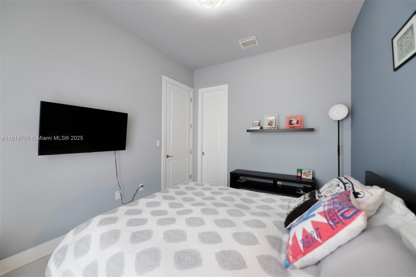 3318 Day Avenue, Unit 7 Miami, FL 33133 - Photo 34 of 39 a bedroom with a bed and a flat screen tv