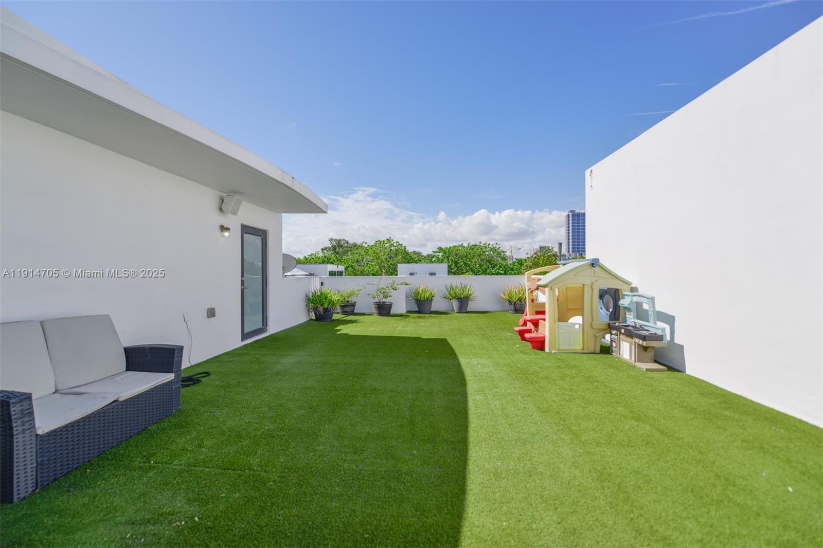 3318 Day Avenue, Unit 7 Miami, FL 33133 - Photo 38 of 39 a front view of a house with a yard and garage