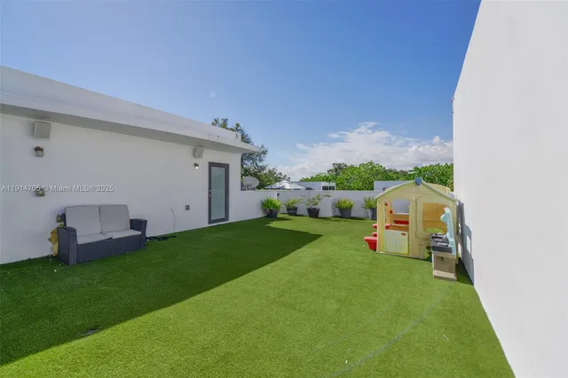 a view of a backyard with furniture
