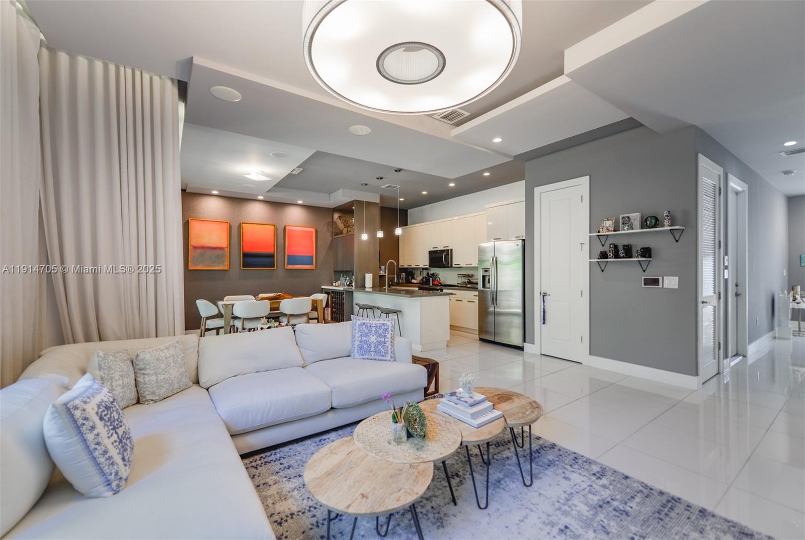 3318 Day Avenue, Unit 7 Miami, FL 33133 - Photo 6 of 39 a living room with furniture and a dining table with wooden floor
