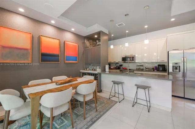 a kitchen with stainless steel appliances kitchen island granite countertop a sink and cabinets