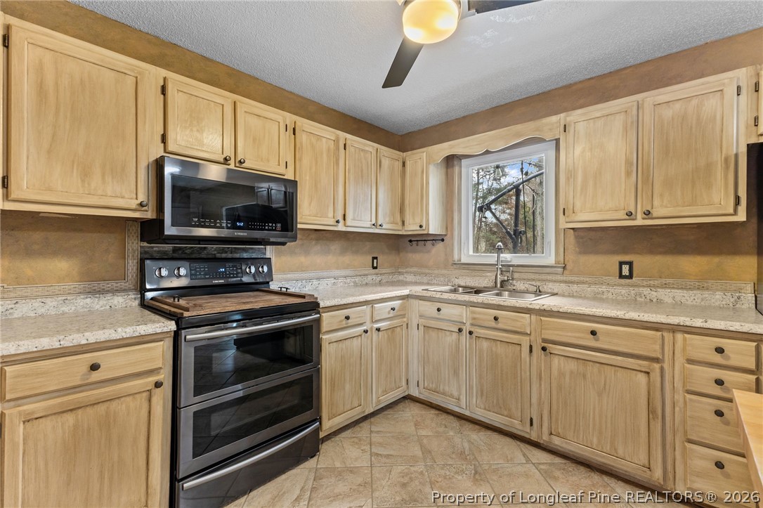 237 Lemuel Black Road Bunnlevel, NC 28323 - Photo 18 of 37 a kitchen with appliances a sink and cabinets