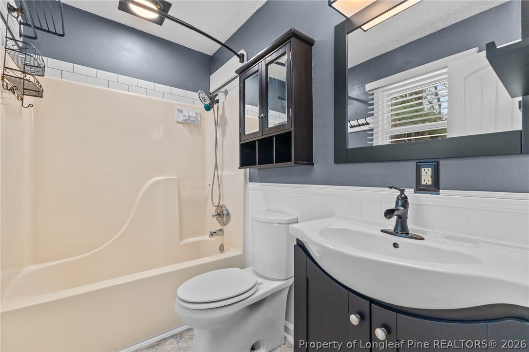 237 Lemuel Black Road Bunnlevel, NC 28323 - Photo 7 of 37 a bathroom with a sink a toilet and shower