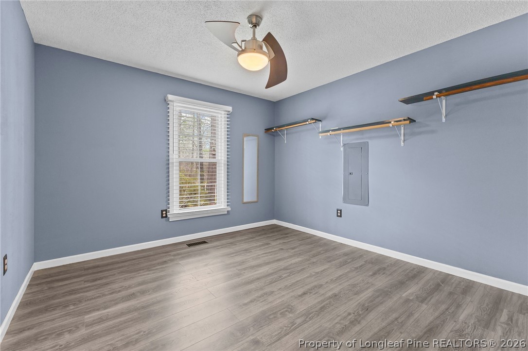 237 Lemuel Black Road Bunnlevel, NC 28323 - Photo 8 of 37 a view of empty room with wooden floor and fan