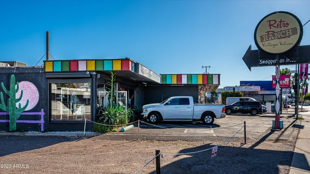 a living room with furniture a window and a clock
