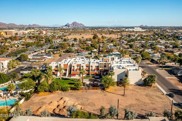 an aerial view of residential houses with city view