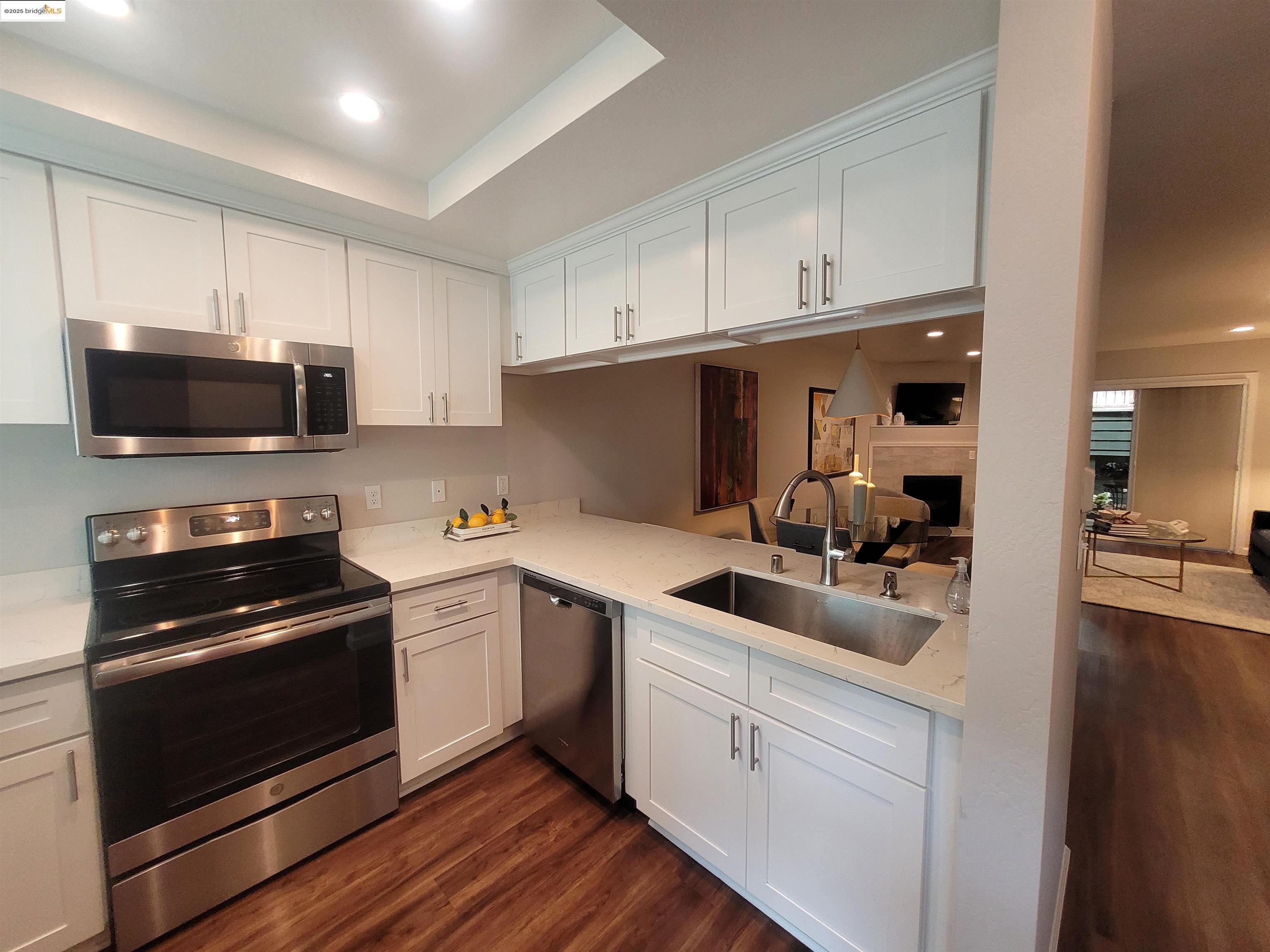 a kitchen with a sink a stove and cabinets