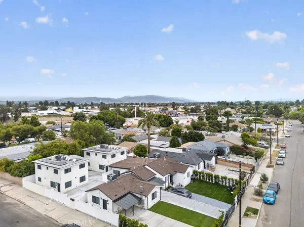 an aerial view of residential houses with city view