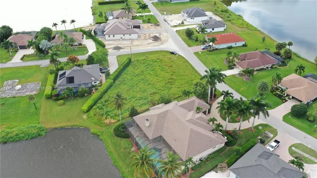an aerial view of residential houses with outdoor space and street view