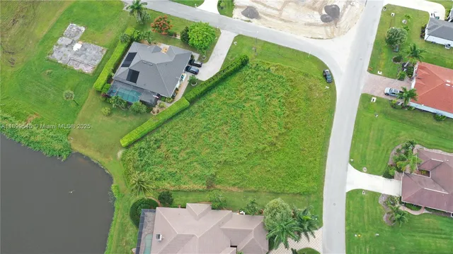 an aerial view of a house with a yard and outdoor seating