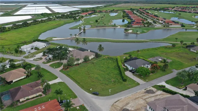 an aerial view of a residential houses with outdoor space and street view