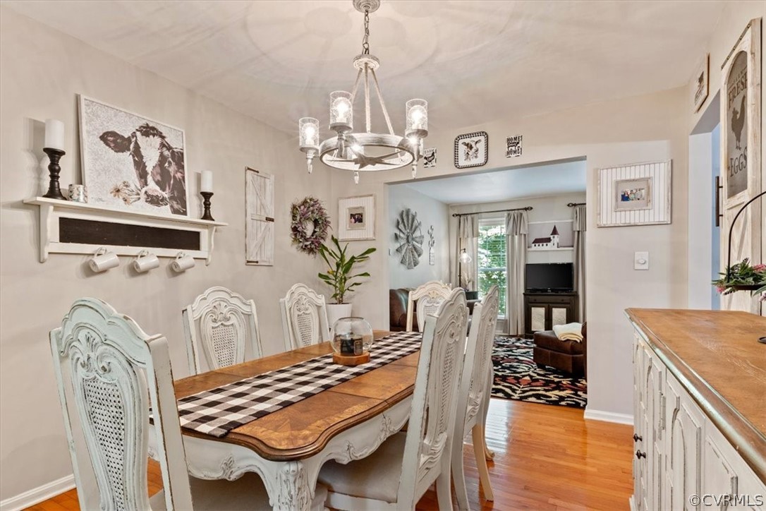 251 Cedar Ridge Drive Ruther Glen, VA 22546 - Photo 3 of 30 a view of a dining room with furniture a chandelier and wooden floor
