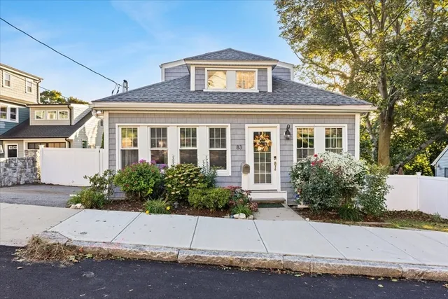 a front view of a house with a yard and a garage