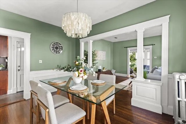 a view of a dining room with furniture wooden floor and chandelier