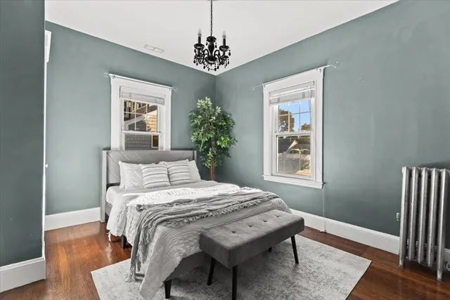 a bedroom that has a bed and a dresser in it