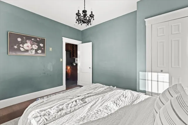 a bedroom with bed and a window