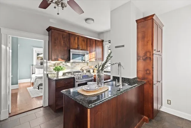 a kitchen with sink refrigerator and cabinets