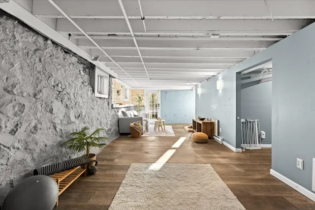 a living room with furniture and wall paintings