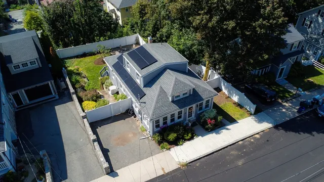 an aerial view of a house with a swimming pool