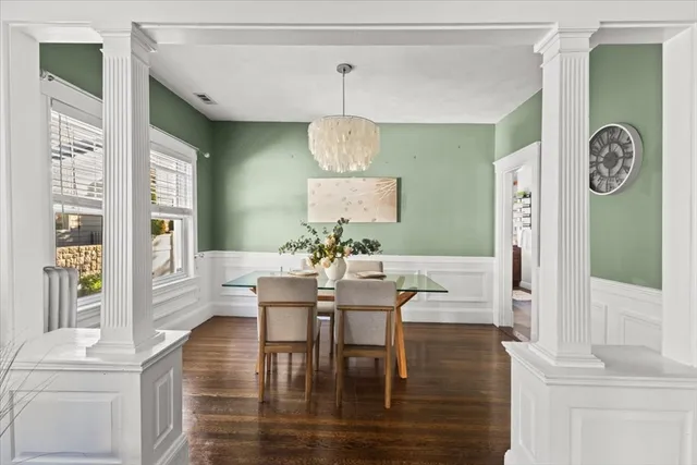 a view of a dining room with furniture window and wooden floor