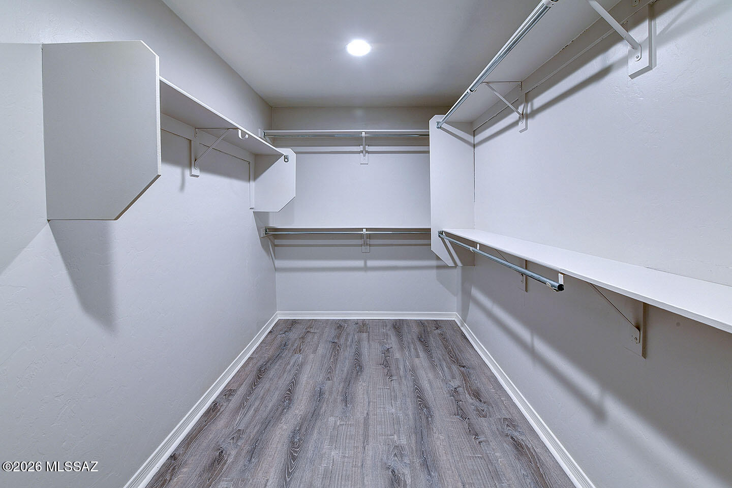 13464 North Piemonte Way Oro Valley, AZ 85755 - Photo 20 of 33 a view of walk in closet with wooden floor