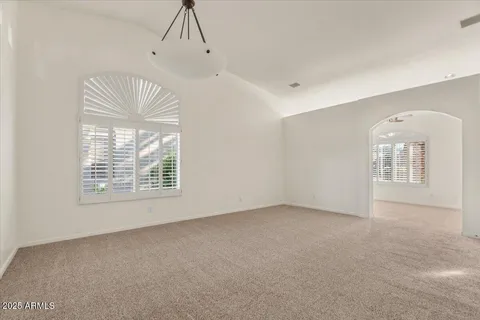 a view of a big room with closet and windows