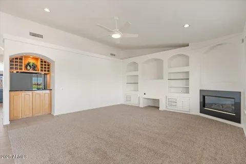 a kitchen with kitchen island granite countertop a sink counter top space appliances and cabinets