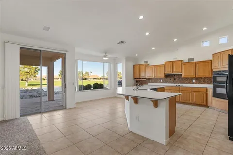 a large kitchen with stainless steel appliances kitchen island a large counter top and a stove