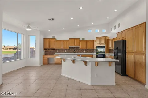 a large white kitchen with stainless steel appliances